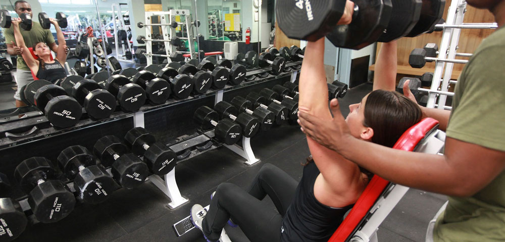 Sgt. Poopers can remove and control gym odors by killing the bacteria that cause odor. Image of people exercising at the gym