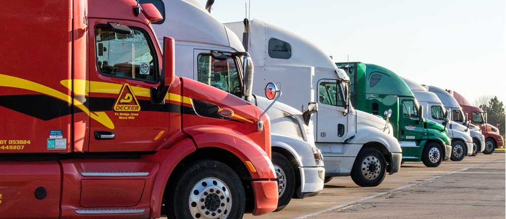 Sgt. Poopers eliminates odors by killing the germs that cause odor. Image of a row of semi trucks