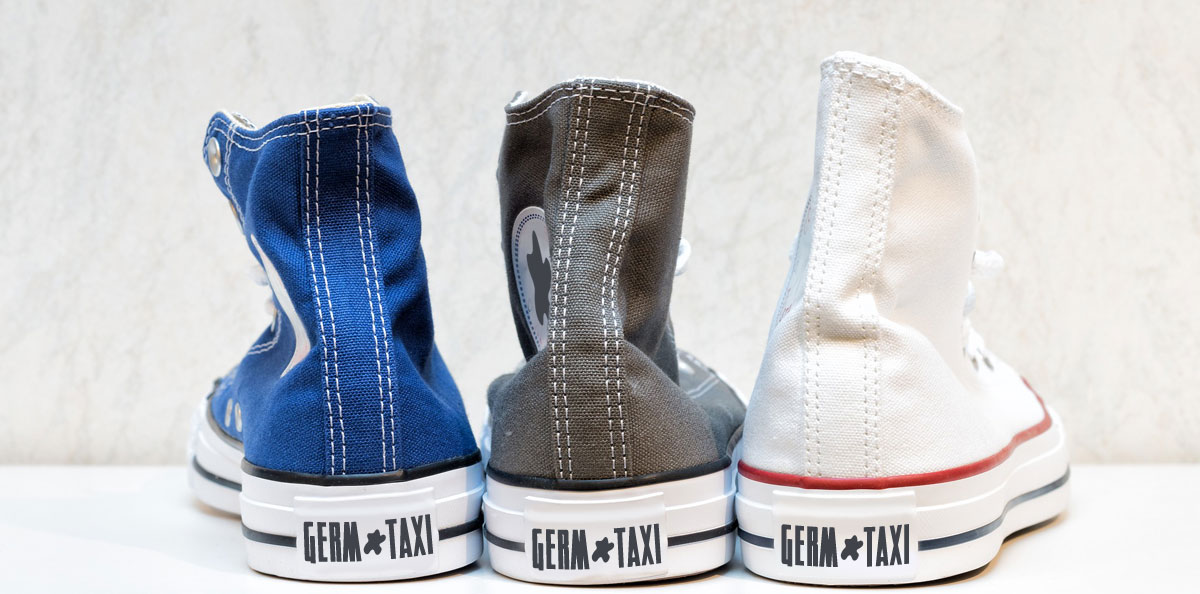 Image of shoes that say "Germ Taxi" on them